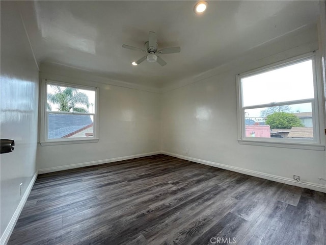 unfurnished room with dark hardwood / wood-style flooring and ceiling fan