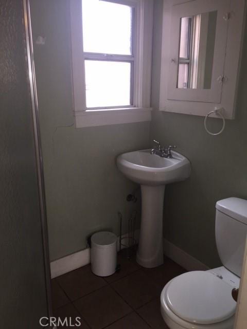 bathroom with tile patterned flooring and toilet