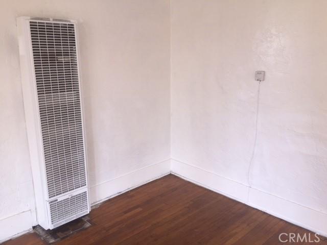 spare room featuring dark wood-type flooring