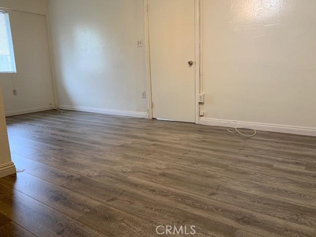 empty room with dark hardwood / wood-style floors