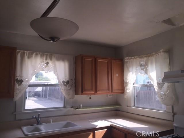 kitchen featuring premium range hood, sink, and range