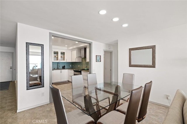 dining room featuring light tile patterned flooring and sink