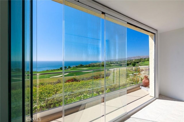 unfurnished sunroom featuring a water view