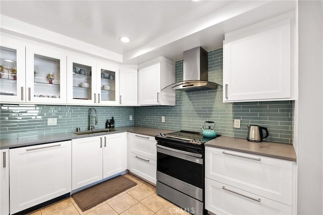 kitchen featuring dishwasher, wall chimney exhaust hood, white cabinetry, sink, and stainless steel electric range oven