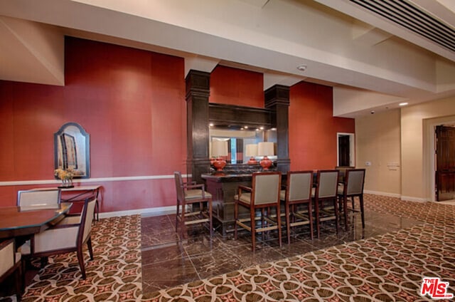 dining room featuring bar area