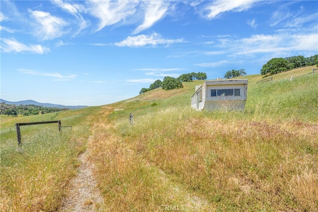 view of yard featuring a mountain view and a rural view