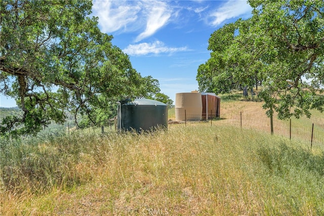 view of yard with a rural view and an outdoor structure