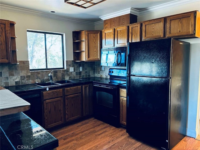 kitchen with black appliances, dark wood-type flooring, crown molding, and backsplash