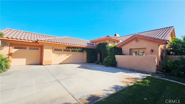 mediterranean / spanish house with a garage