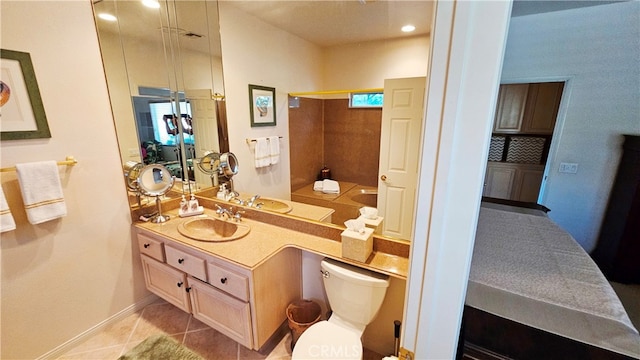 bathroom featuring oversized vanity, tile flooring, and toilet