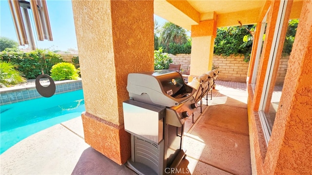 view of terrace featuring a fenced in pool and grilling area