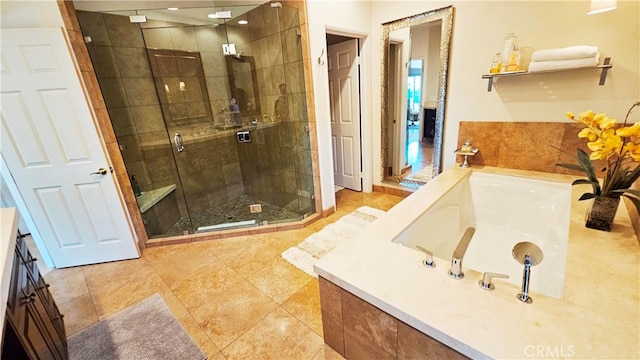 bathroom with tile floors, vanity, and independent shower and bath