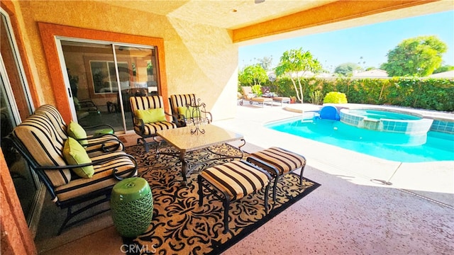 view of pool featuring a patio area and an in ground hot tub