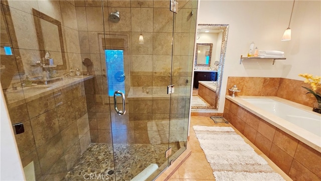 bathroom featuring shower with separate bathtub, tile floors, and vanity