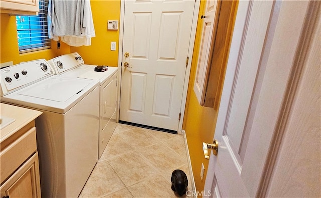 washroom featuring separate washer and dryer and light tile floors