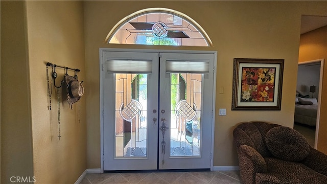 entrance foyer with french doors and light tile flooring