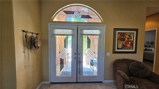 foyer entrance with french doors and light tile flooring