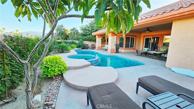 view of swimming pool with a patio area, an in ground hot tub, and ceiling fan