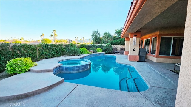 view of swimming pool with a patio area and an in ground hot tub