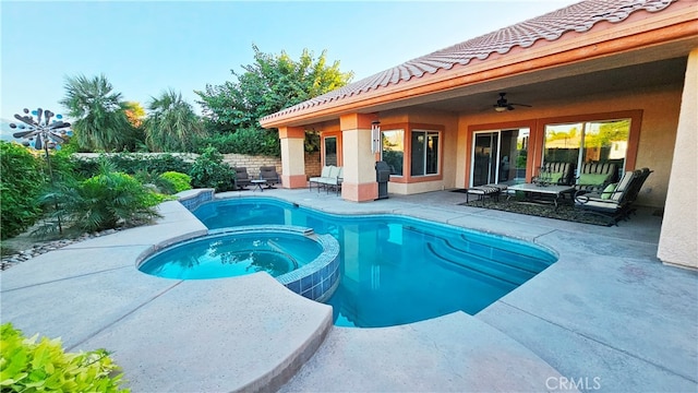 view of swimming pool with ceiling fan, a patio area, and an in ground hot tub