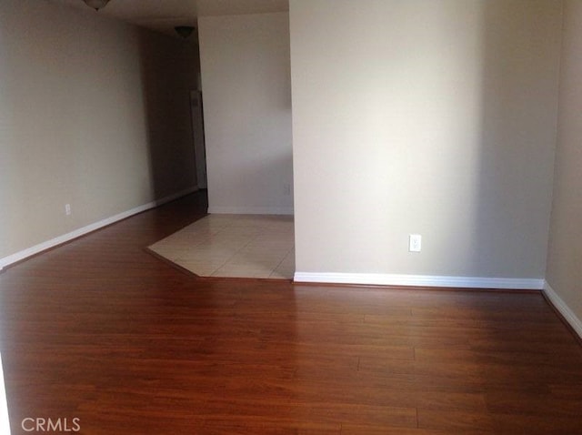 unfurnished room featuring dark hardwood / wood-style flooring