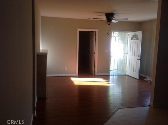 spare room with ceiling fan and dark hardwood / wood-style floors