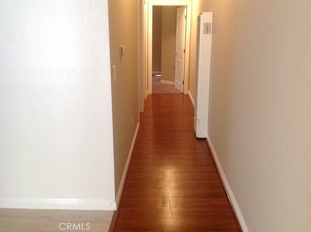 hall with dark wood-type flooring