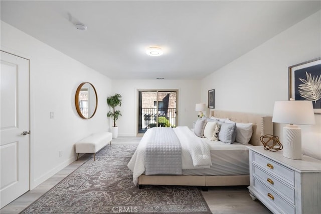 bedroom with access to exterior and dark hardwood / wood-style flooring