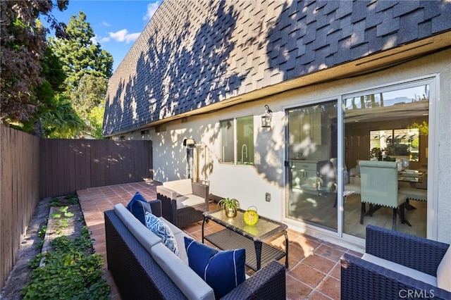 wooden terrace featuring an outdoor hangout area, a patio area, and sink