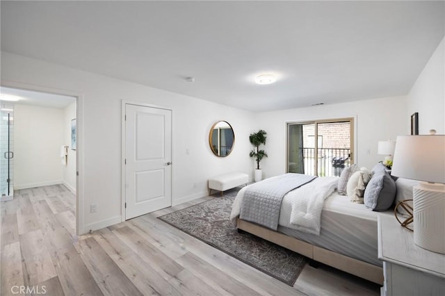 bedroom with access to exterior and light hardwood / wood-style flooring