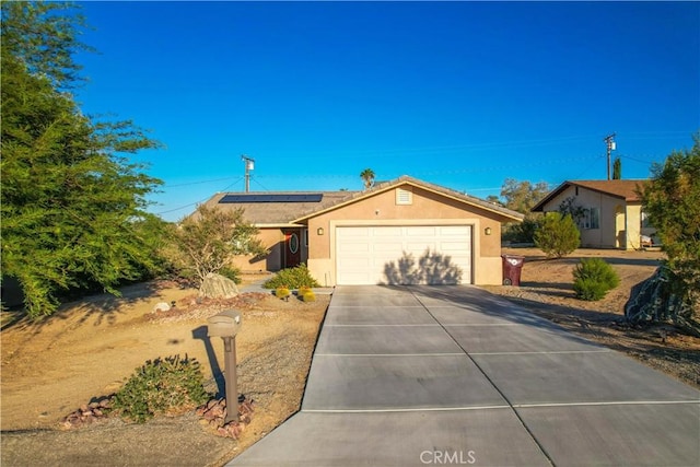 ranch-style house with solar panels and a garage