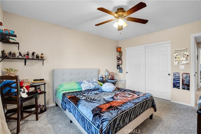 carpeted bedroom featuring ceiling fan and a closet