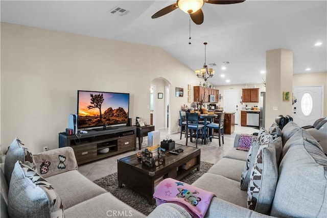 living room featuring ceiling fan with notable chandelier, lofted ceiling, and light tile patterned flooring