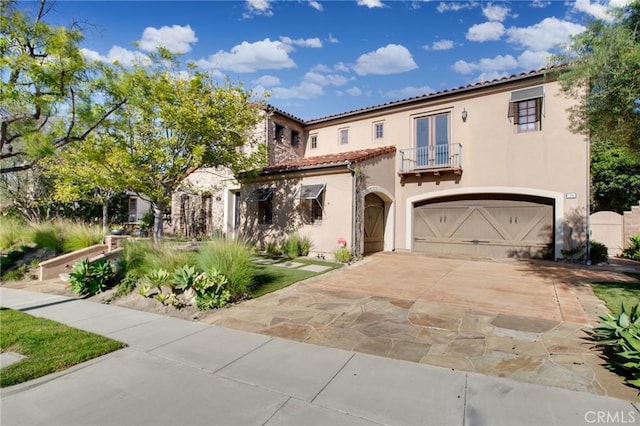 mediterranean / spanish-style house with a balcony and a garage