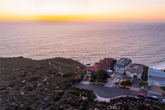 aerial view at dusk with a water view