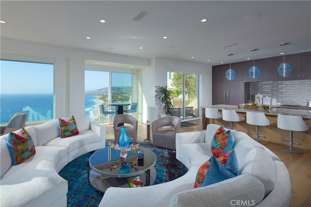 living room with a water view and dark wood-type flooring