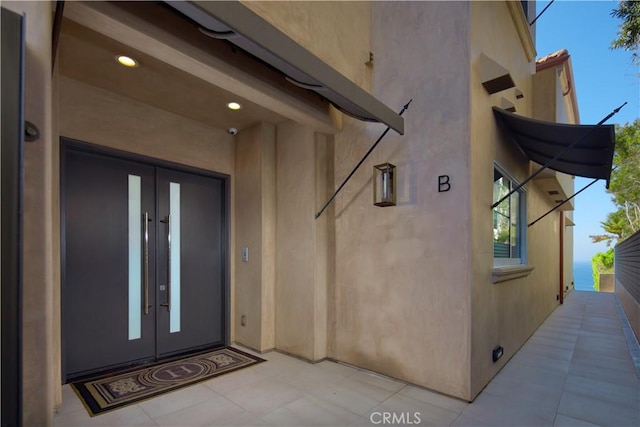 view of exterior entry featuring french doors