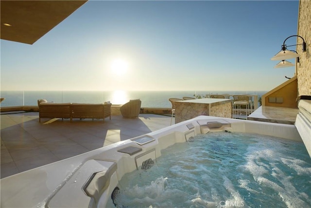 view of pool featuring a water view and a hot tub