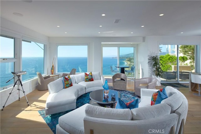 sunroom / solarium featuring a water view