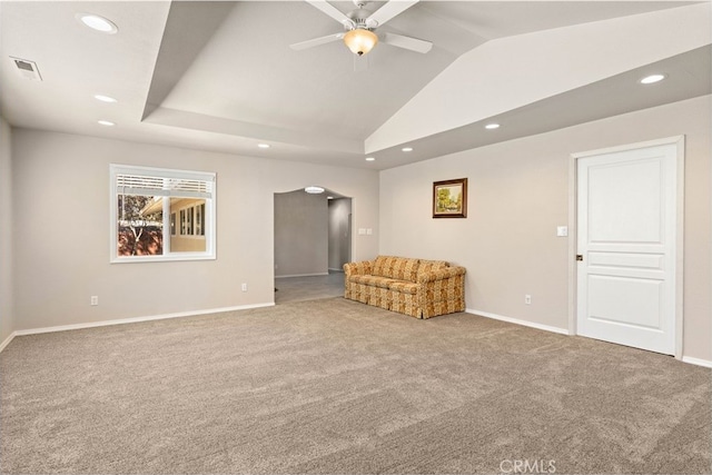 unfurnished room with ceiling fan, vaulted ceiling, and light colored carpet