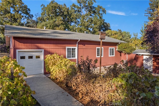 view of side of home featuring a garage