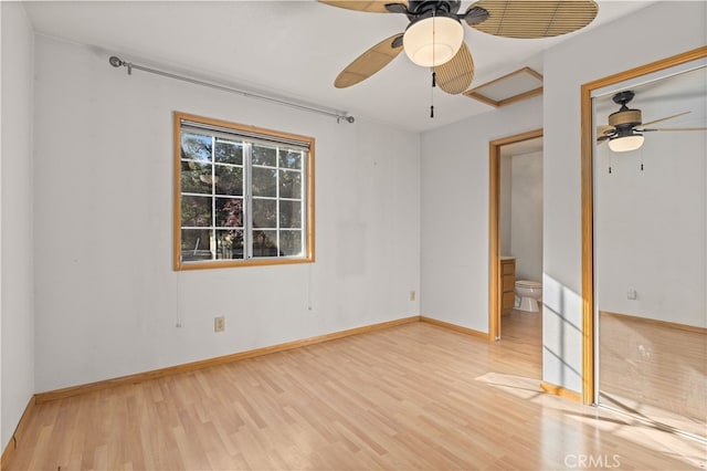 unfurnished bedroom featuring ceiling fan, connected bathroom, and light hardwood / wood-style floors