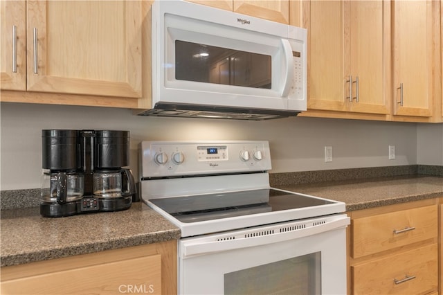 kitchen with white appliances and light brown cabinetry