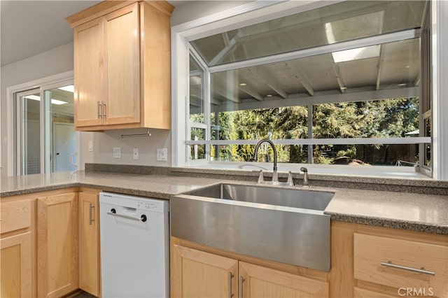 kitchen featuring sink, light brown cabinetry, and white dishwasher