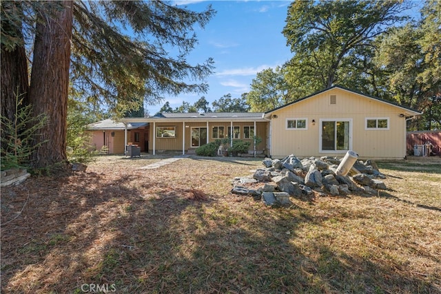 rear view of house with a yard