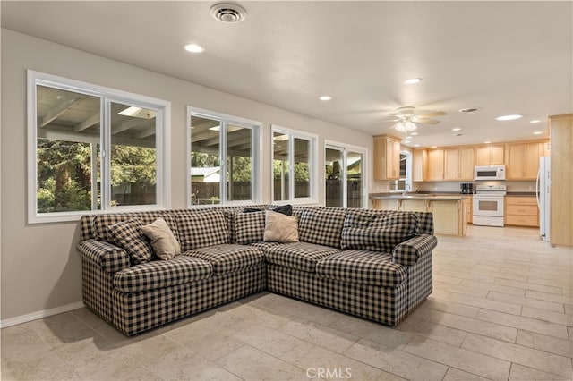 tiled living room with ceiling fan