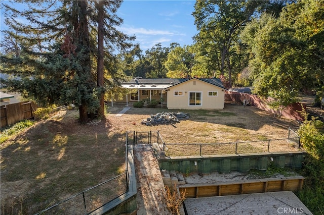 rear view of property with a lawn