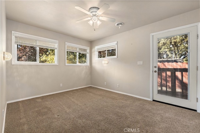 carpeted empty room featuring ceiling fan