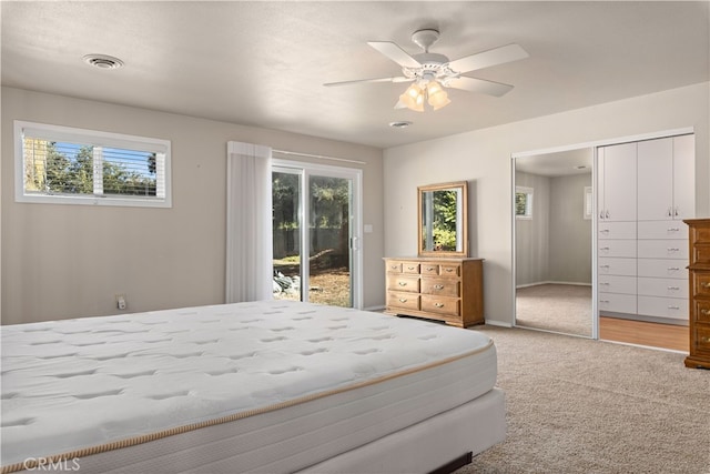 bedroom with light carpet, multiple windows, access to outside, and ceiling fan