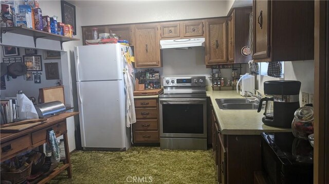 kitchen featuring electric range, white refrigerator, and sink